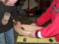 Brian and Douglas help with the gouging of Stephen's hull. Photo: SR